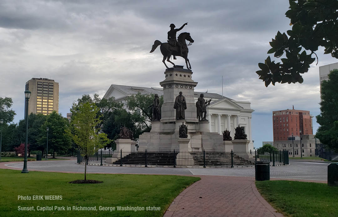 Sunset at the Capitol park in Richmond with the George Washington Statue and the James Monroe Federal Building in the distance reflecting dusk sun colors