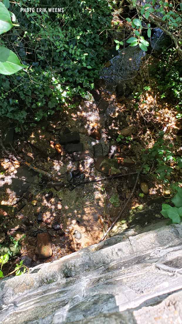 Running water under the stone walkway