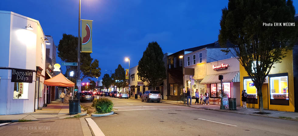 Watermelon Fest banner at night on Carytown street